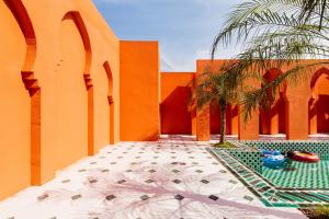 a courtyard of a building with a palm tree and a pool at Shanghai Half-Window Hotel in Shanghai