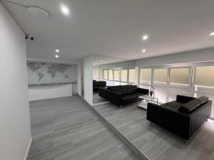 a living room with two couches and a map on the wall at Hostel Hock Residences in Hospitalet de Llobregat