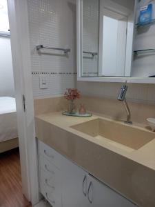 a bathroom counter with a sink and a mirror at Apartment Seaview all rooms in Florianópolis