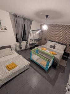 a room with two beds and a table in it at Klagenfurt Apartment in Klagenfurt