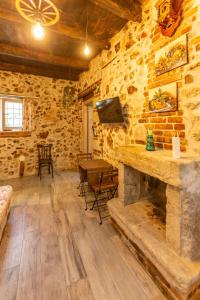 a living room with a stone wall and a tv at Casicarillo 800 in Serino