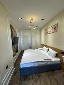 a bedroom with a large bed and a tv at Luxury apartment at 16th floor of Akay city in Tashkent near metro in Salor Bekati +10 photos