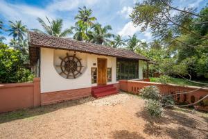 a small house with a door in a yard at Emerald Isle in Alleppey +37 photos