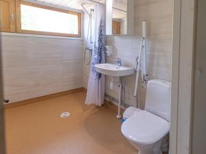a bathroom with a white toilet and a sink at Käringsund Resort in Eckerö +123 photos