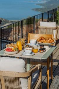 a table with breakfast food on a balcony at Torra di l alba in Viggianello