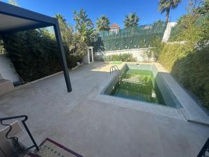 a swimming pool in the middle of a patio at Dar Salma in Tangier