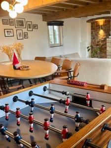 a living room with a large billiard table and a table at Hoeve Gensters in Oudenaarde