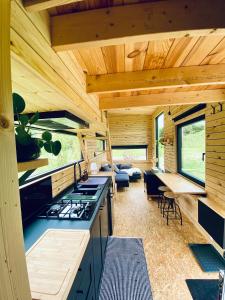 a kitchen and living room of a log cabin at Tinyhouse au coeur d'un vignoble in Floreffe +22 photos