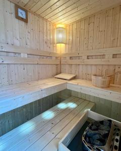 a wooden sauna with a bench in it at Nyárfás Panoráma Vendégház in Dunavarsány +57 photos