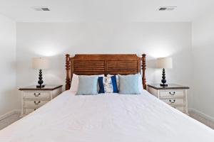 a bedroom with a large bed with two night stands at SG10C: 10C Seagrove Villa in Isle of Palms +25 photos