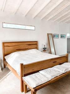 a bedroom with a large wooden bed and a window at Casa de Lujo de Tenis con Pileta Padel y Gimnasio in Garín