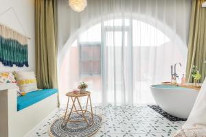 a bathroom with a white tub and a sink and a tub at Shanghai Half-Window Hotel in Shanghai +56 photos