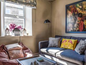 a living room with a couch and a table at Beval Cottage in Abergavenny