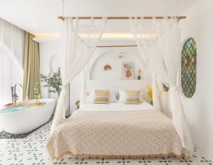 a bedroom with a bed and a bath tub at Shanghai Half-Window Hotel in Shanghai