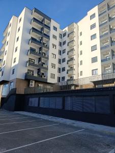 an empty parking lot in front of two buildings at Apartman ANATEO Istocno Sarajevo in Vranješ