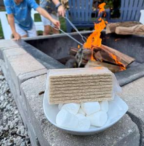 a plate of food on a table with a fire at Spacious 3 Bedroom in Cary