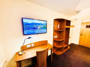 BroadheathにあるALTY Hotelのデスク、壁掛けテレビ付きのオフィス +4枚の写真