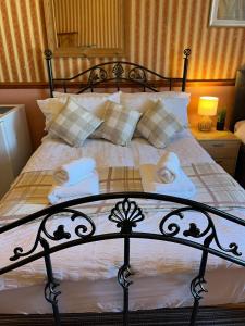 a bedroom with a bed with towels on it at Edinburgh Travel Guest House in Edinburgh