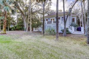 a white house with trees in front of it at OG14: 14 Ocean Green in Kiawah Island