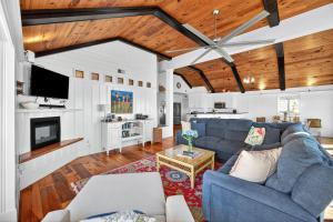 a living room with a blue couch and a kitchen at PW1310: 1310 Pelican Watch in Seabrook Island