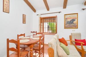 a dining room with a table and chairs at Cortijo A Navas in Frigiliana