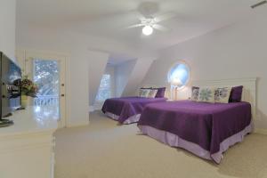 Un dormitorio con dos camas con sábanas moradas y un televisor. en SM04: 4 Silver Moss, en Kiawah Island 44 fotos más