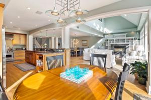 a dining room and living room with a table and a kitchen at SS52: 52 Surfsong in Kiawah Island