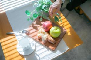 a table with a cutting board with apples and croissants at Marina blue zushi in Zushi