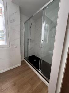 a shower with a glass door in a bathroom at Hamilton Suites in Barcelona