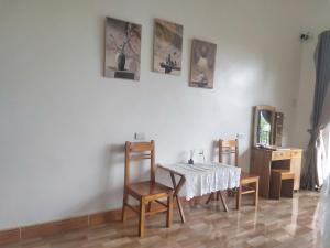 a dining room with a table and some pictures on the wall at Mai Hill Homestay in Lũng Tiềm +29 photos