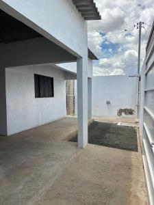 a white house with a view of the ocean at Casa LF com suíte e garagem coberta in Mineiros