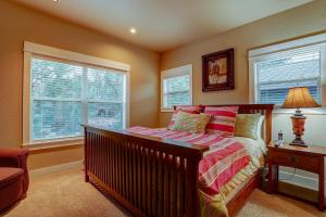 a bedroom with a bed and two windows at Big Pine in Bend