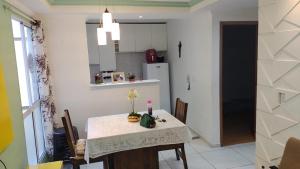 a kitchen and dining room with a table and chairs at Apartamento em Maceió in Maceió