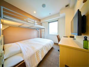 a bedroom with a bunk bed and a desk at Super Hotel Fujinomiya in Fujinomiya +91 photos