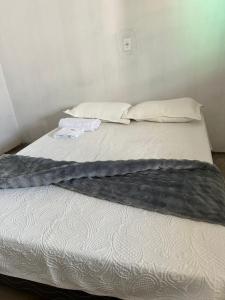 two beds in a room with towels on them at Casa LF com suíte e garagem coberta in Mineiros