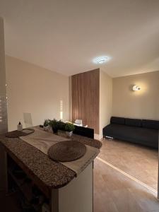 a living room with a kitchen with a couch at Modern Apartment - MIND District, Fiera Milano Rho in Baranzate