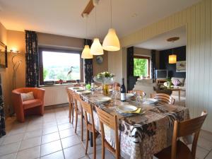 a dining room with a long table and chairs at Ondenval Stay with Sauna in Waimes