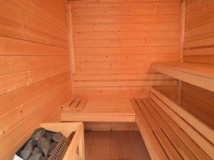 a wooden sauna with two benches in it at Ondenval Stay with Sauna in Waimes