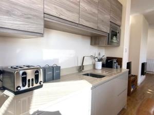 a kitchen with a counter top with a toaster at Cliff Top Apartment in Filey
