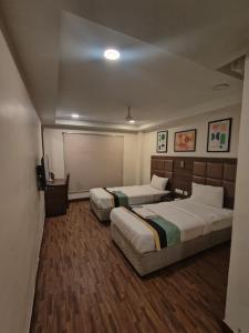 Una cama o camas en una habitación de Welcome Inn Boutique Hotel