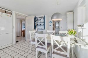 een keuken en eetkamer met een tafel en stoelen bij Family-Friendly Beachside Holiday Home in Arnager +18 foto's