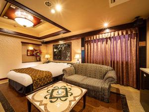 een hotelkamer met een bed en een stoel bij Hotel LaLa (Adult Only) in Sakai +67 foto's