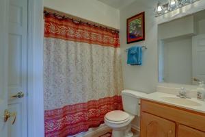 a bathroom with a toilet and a shower curtain at Amber Sunset in Mosier +22 photos