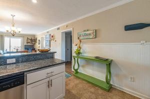 a kitchen with a green table in a room at Perfect Ocean View - Oceanfront Condo, Private Balcony, Community Pool in Kill Devil Hills