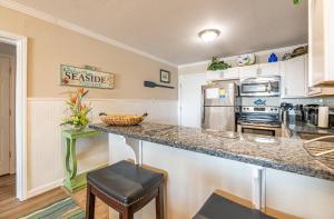 a kitchen with a counter top in a room at Perfect Ocean View - Oceanfront Condo, Private Balcony, Community Pool in Kill Devil Hills