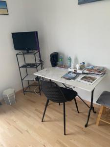 a white desk with a chair and a computer monitor at Le Teich Tranquille in Le Teich