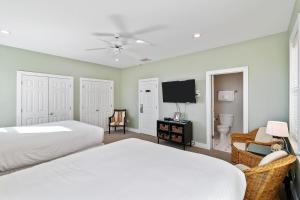 a bedroom with two beds and a flat screen tv at GP132: 132 Grand Pavilion in Isle of Palms