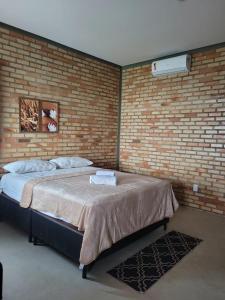 Ένα ή περισσότερα κρεβάτια σε δωμάτιο στο Pousada Flor do Café