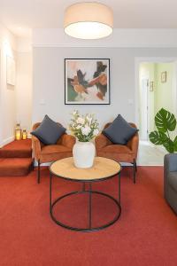 a living room with a vase of flowers on a table at Sunnyholme - New! Yorkshire Luxurious Cottage in Hawes