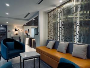 a living room with a couch and a chair at La Quinta by Wyndham Atlanta Roswell in Roswell